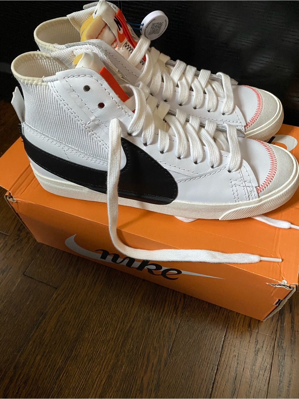 Nike White High-Top Sneakers with Black Swoosh and Orange Accents